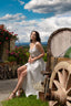 A woman in an Italian town in a romantic dress and idyllic atmosphere. Dressed in a long dress