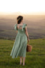 Romantic sage green dress with delicate butterfly sleeves and a flattering waistline