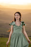 Sage green wedding dress with romantic fluttery sleeves and a flowing hemline