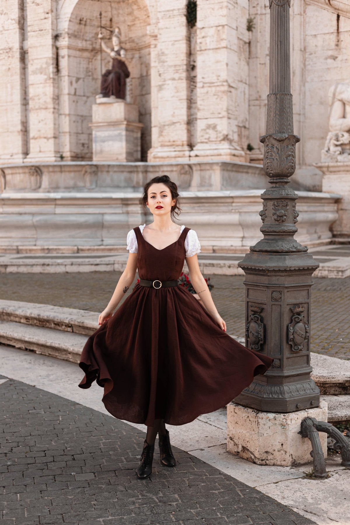 Front view of the Andalusia dark brown linen dress with a swirling full circle skirt in Rome