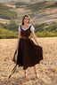 Andalusia dark brown linen midi dress styled with a white blouse in the countryside