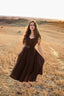 Full-length front view of the Andalusia dark brown linen dress with a flowing circle skirt