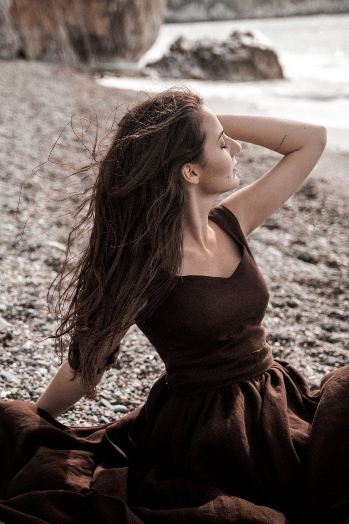 Close-up of the Andalusia dark brown linen dress showing the neckline and natural linen texture.