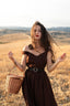 Andalusia dark brown linen dress with sweetheart neckline styled with a woven basket
