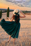 Back view of the Andalusia emerald green linen dress with a flowing full circle skirt