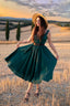 Front view of the Andalusia emerald green linen dress with a dramatic full circle midi skirt