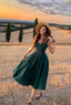 
Andalusia emerald green linen dress with a full circle skirt photographed in a sunlit countryside field