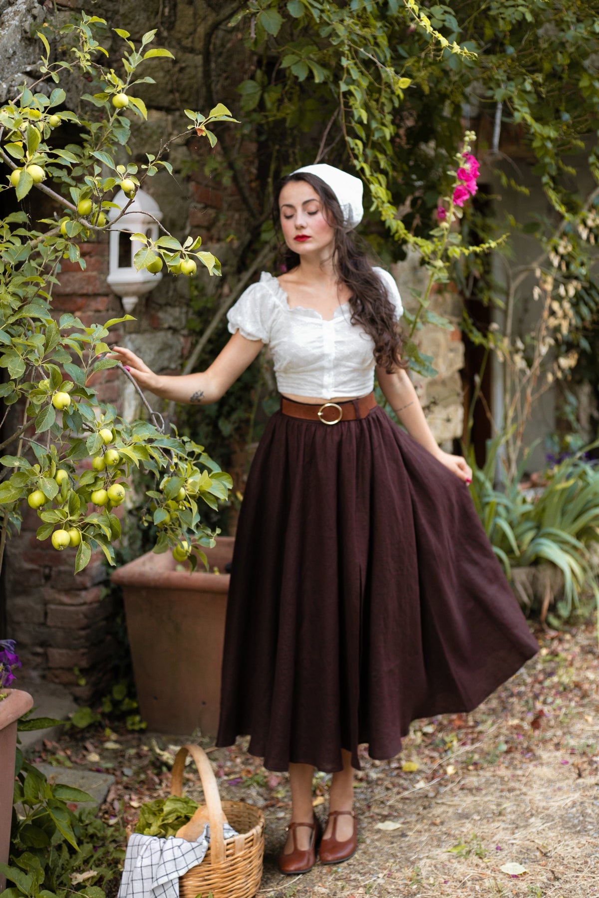Full-length view of the Ellie dark brown linen midi skirt showing its softly flared silhouette