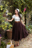Full-length view of the Ellie dark brown linen midi skirt showing its softly flared silhouette