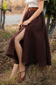 Close-up of the Ellie dark brown linen skirt showing the front slit and natural linen texture