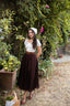 Three-quarter view of the Ellie dark brown linen midi skirt styled with a romantic white blouse