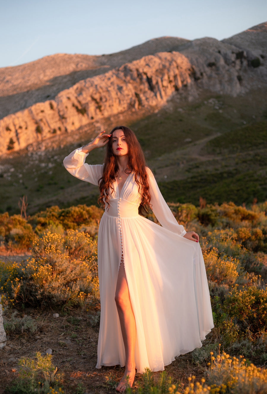 Moonlight in Marrakesh white silk georgette long-sleeve wedding dress with a front slit, in the mountains at sunset