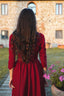 Full back view of the Siena burgundy linen midi dress photographed in a historic courtyard