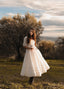 Under the Tuscan Sky ivory linen wedding dress with a flowing skirt photographed in an olive grove