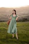 Romantic sage green dress with delicate butterfly sleeves and a flattering waistline